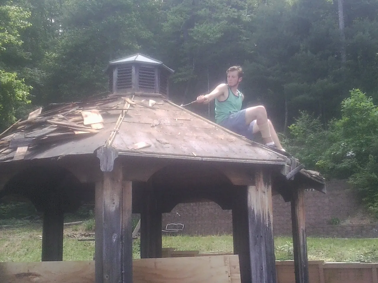 Tearing the old roof off a wooden gazebo before new shakes in Sicklerville