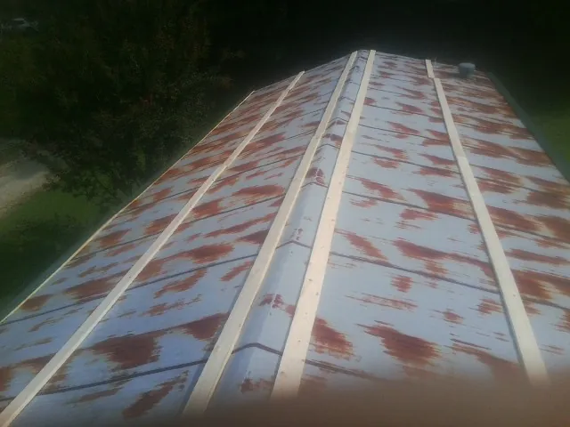 Rusted metal roof panels with new wood purlins before replacement — Storm Damage Roof Repair in Sicklerville by Roofing Brothers